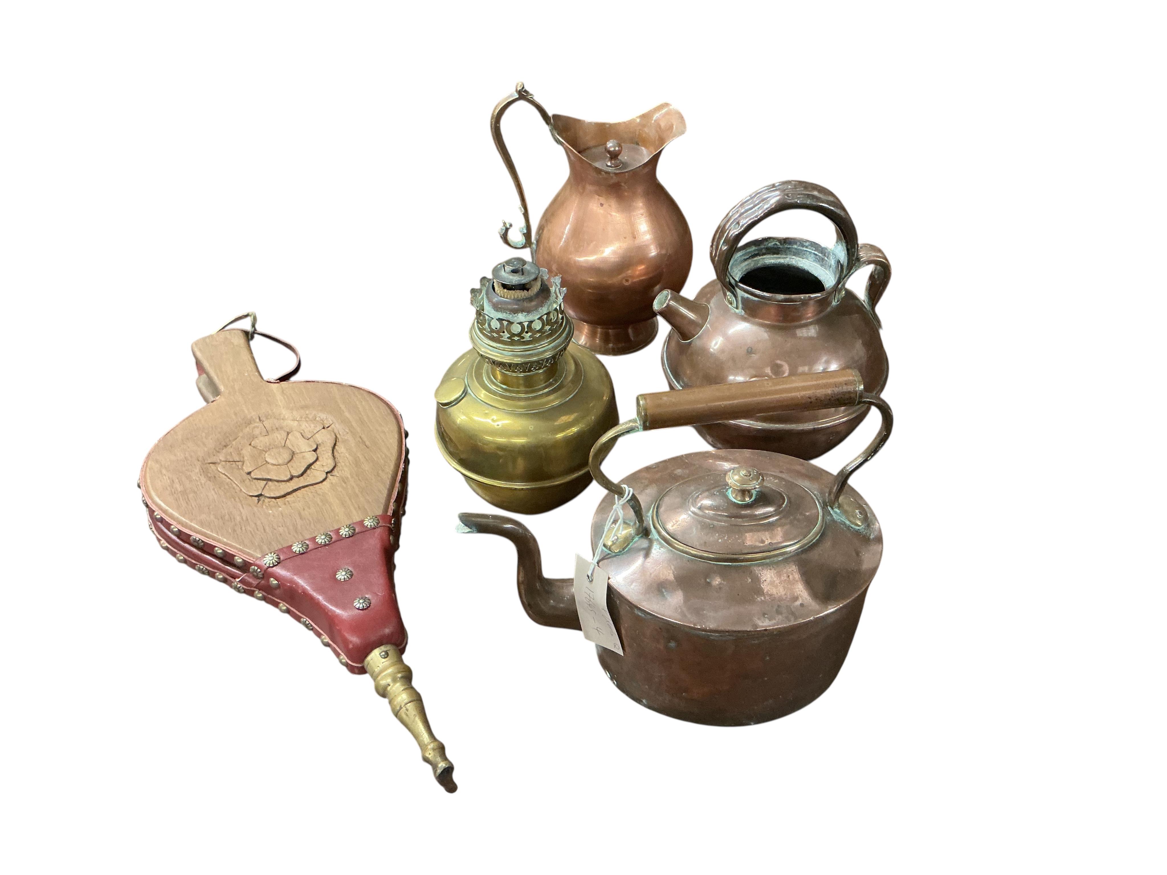 A 19th century copper mounted iron kerb, a set of carved oak bellows together with a collection of Victorian and later copper and brass ware